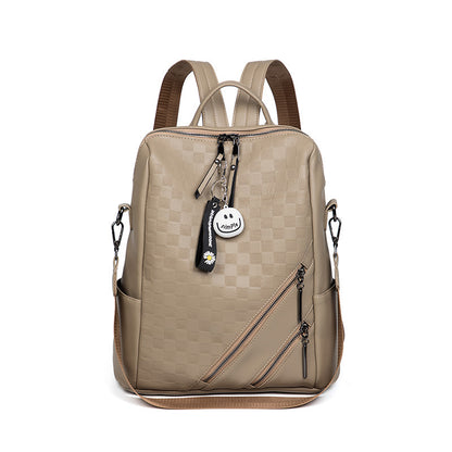 Beige backpack with brown straps on a white background