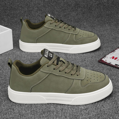 Men's green sneakers with white soles on a gray surface. YAXSO UAE