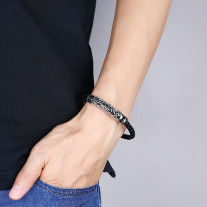 Black leather bracelet with silver tone chain links on wrist