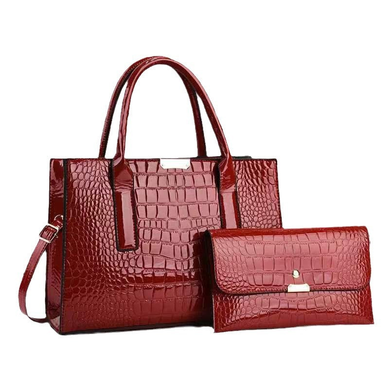 Mother and child bag set in red, croc-texture tote with shoulder strap and clutch