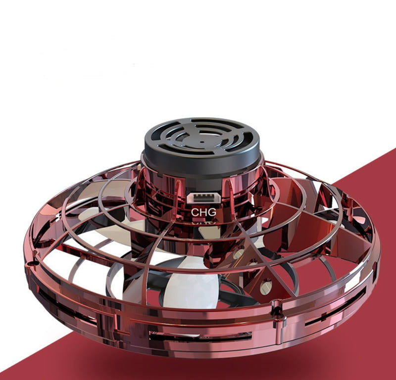 Red mini fingertip spinning toy drone viewed from above with black center