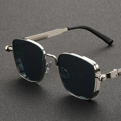 Sunglasses with metallic frame and dark lenses on a gray background