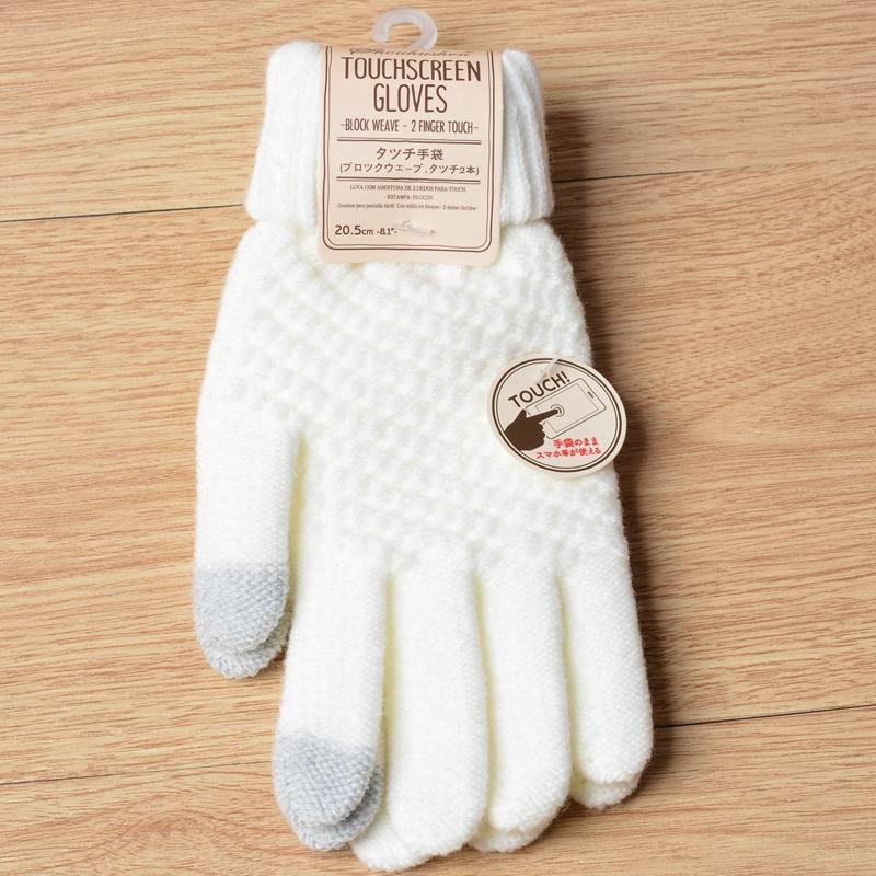 White touchscreen gloves with a label on a wooden surface