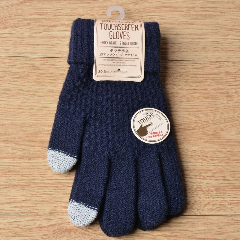 Pair of blue touchscreen gloves with a label on a wooden surface