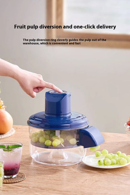 Blue electric grape peeler with clear pulp container and hand pressing the top control