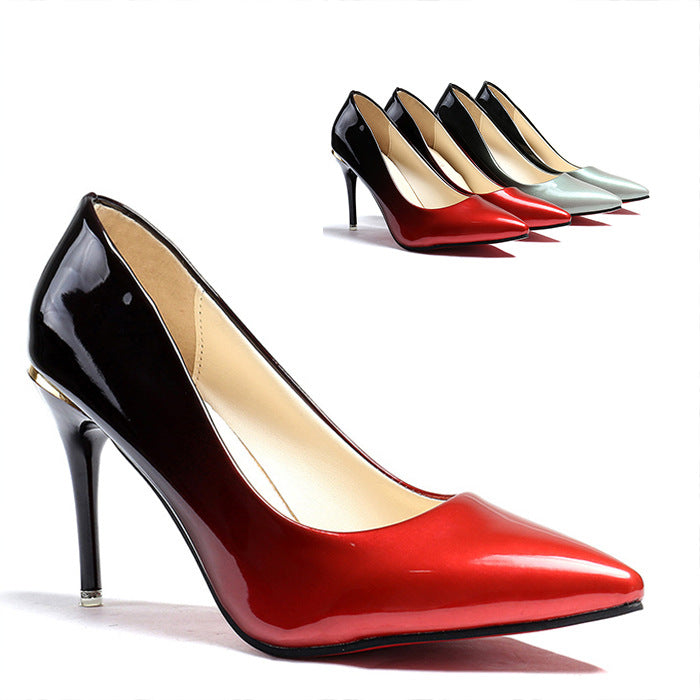 Red high-heeled shoe with a close-up of its sole, surrounded by other colored shoes on a white background.