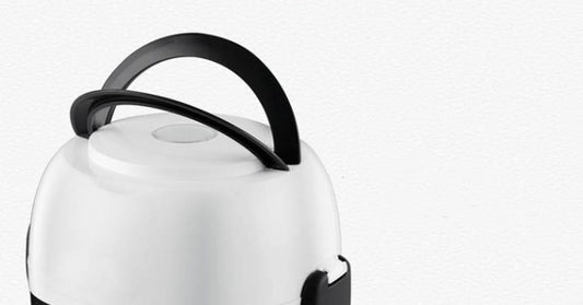 White electric kettle with black handle on a white background