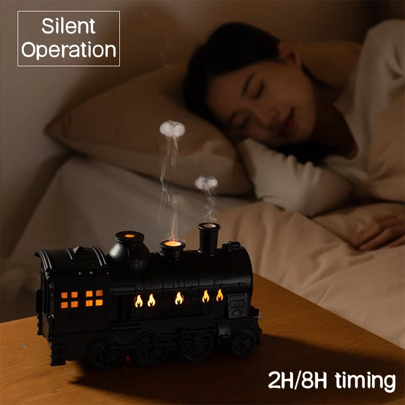 Steam train night light on a bedside table with a person sleeping in the background