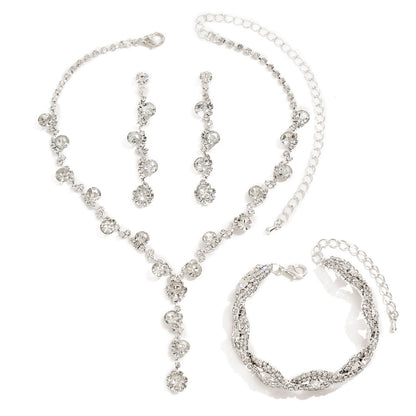 Silver jewelry set including necklace, bracelet, and earrings on a white background