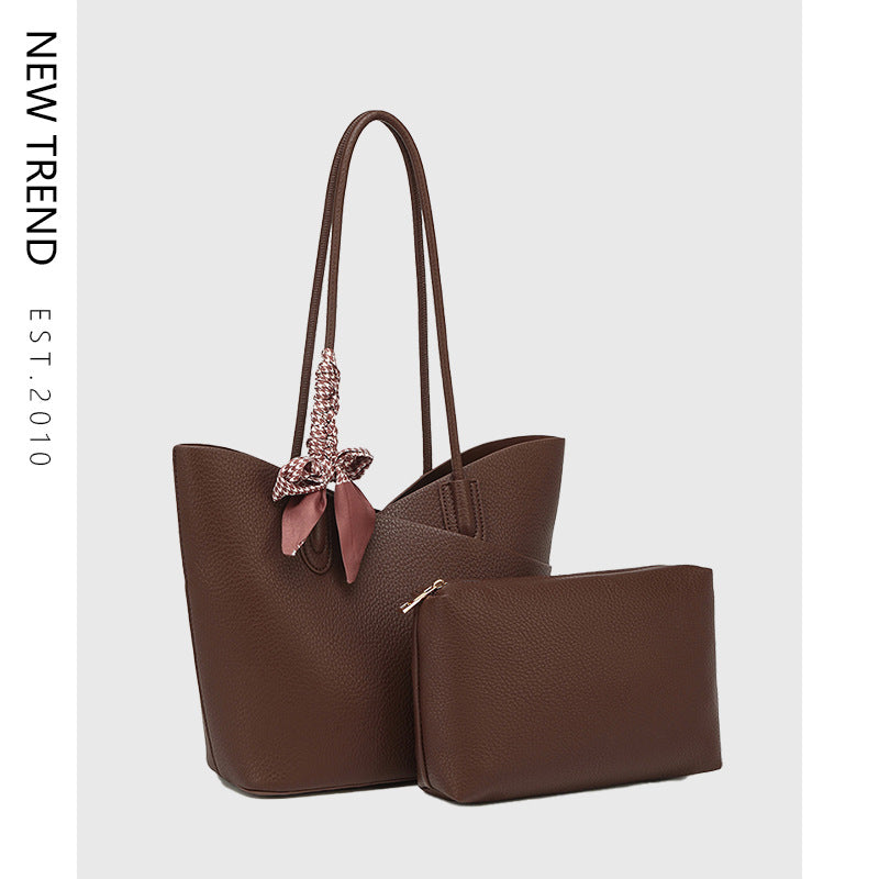 Brown handbag with matching pouch on a light gray background, featuring 'NEW TREND' branding.