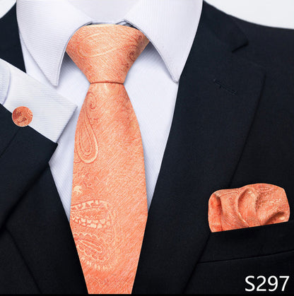 Coral paisley tie and matching pocket square with a black suit and white shirt.