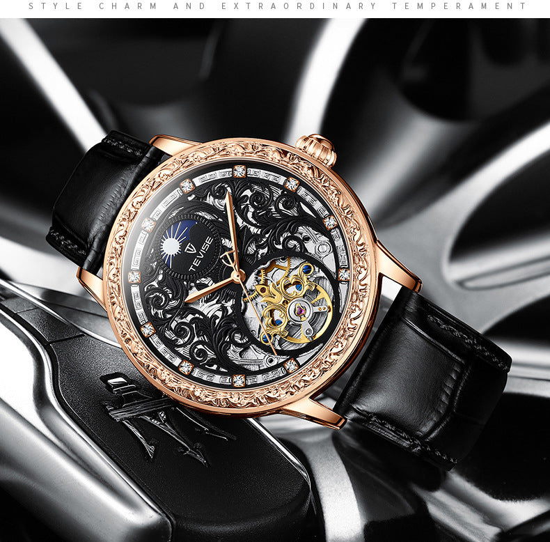 Luxury watch with black leather strap and rose gold case on a metallic background