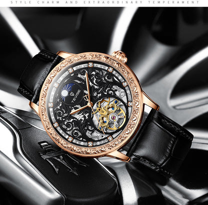 Luxury watch with black leather strap and rose gold case on a metallic background