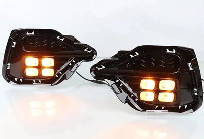 Pair of motorcycle fog lights with amber LEDs on a white background