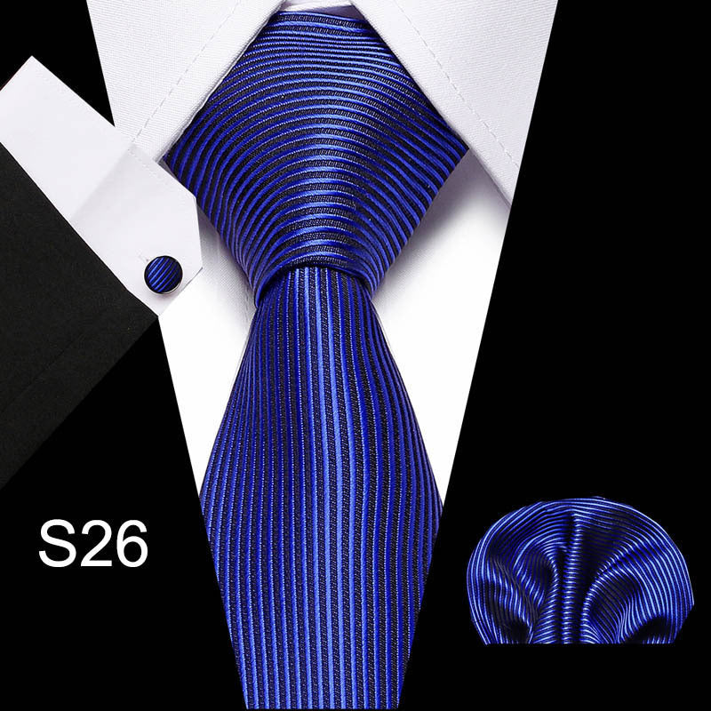 Blue striped tie set with pocket square and cufflinks on a black and white background