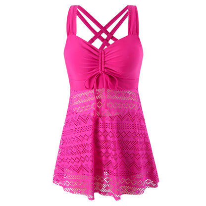 Pink lace dress with criss-cross straps on a white background