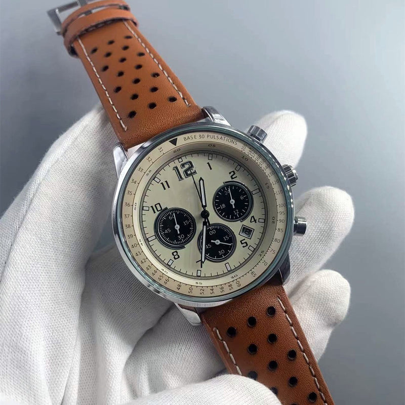 Silver-tone quartz watch with beige dial and perforated brown strap held in a gloved hand