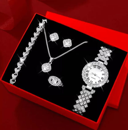 Jewelry set including a watch, bracelet, and earrings in a red box.