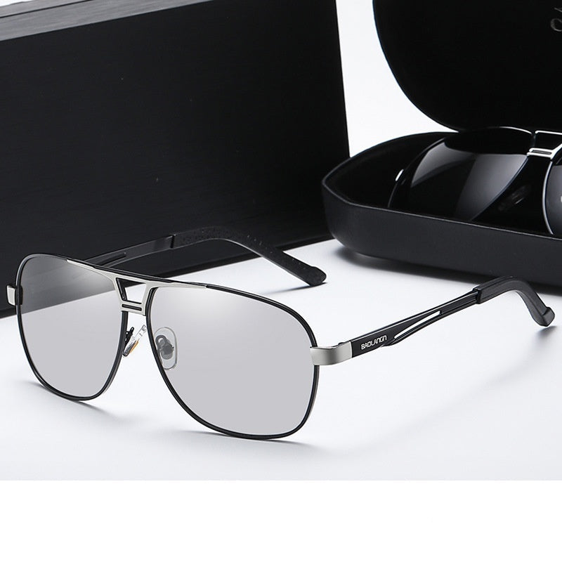 Gun silver frame eyeglasses with color-changing lenses on a white surface.