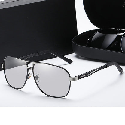 Gun silver frame eyeglasses with color-changing lenses on a white surface.