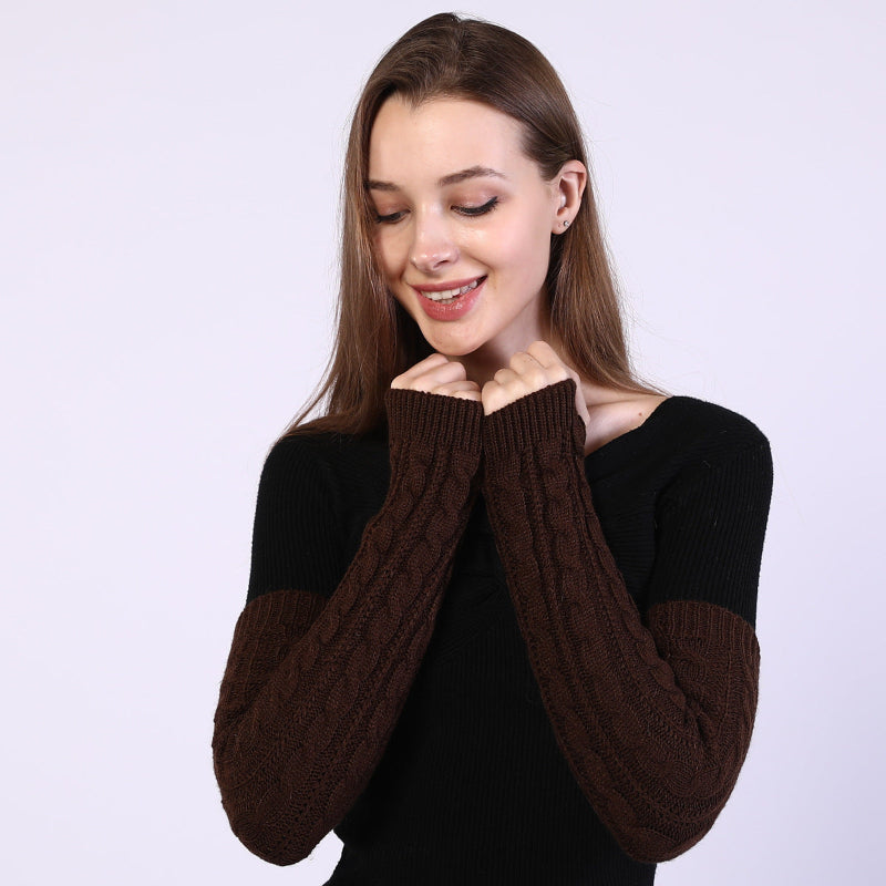 Woman wearing a black and brown sweater against a white background