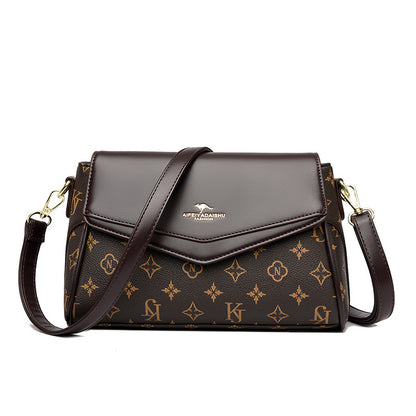 Brown handbag with gold monogram pattern on a white background