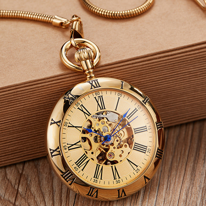 Gold pocket watch with Roman numerals on a wooden surface