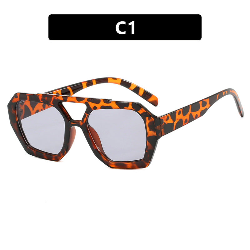 Sunglasses with tortoiseshell frame and clear lenses on a white background