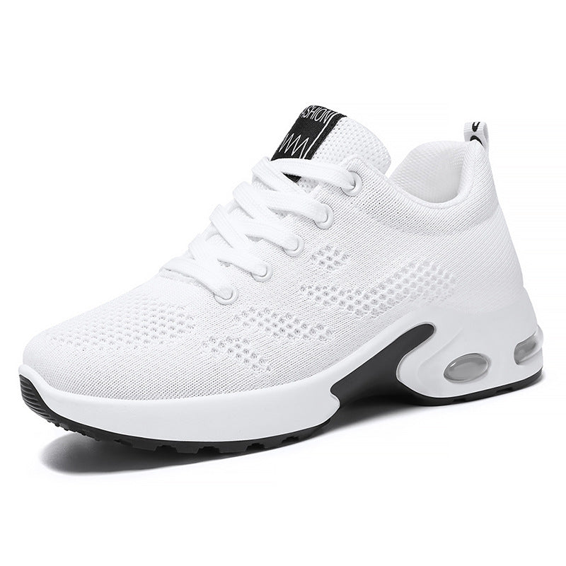 White athletic shoe with black sole on a white background