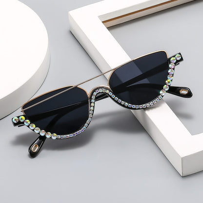 Cat-eye sunglasses with gold frame, dark blue lenses, and multicolor rhinestone border