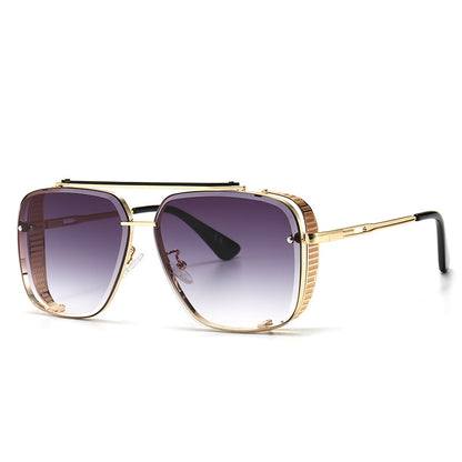 Gold-framed sunglasses with gradient lenses on a white background