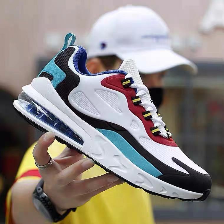 Colorful sneaker held by a person with a blurred background