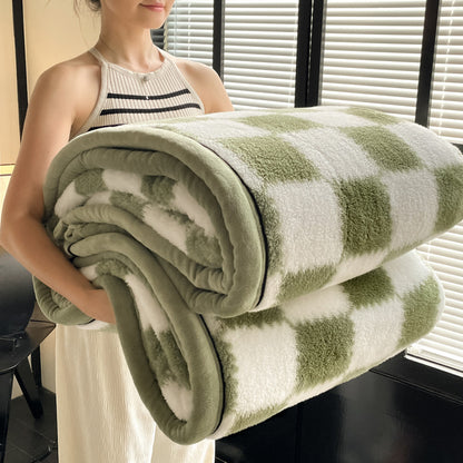 Person holding a green and white striped blanket indoors.