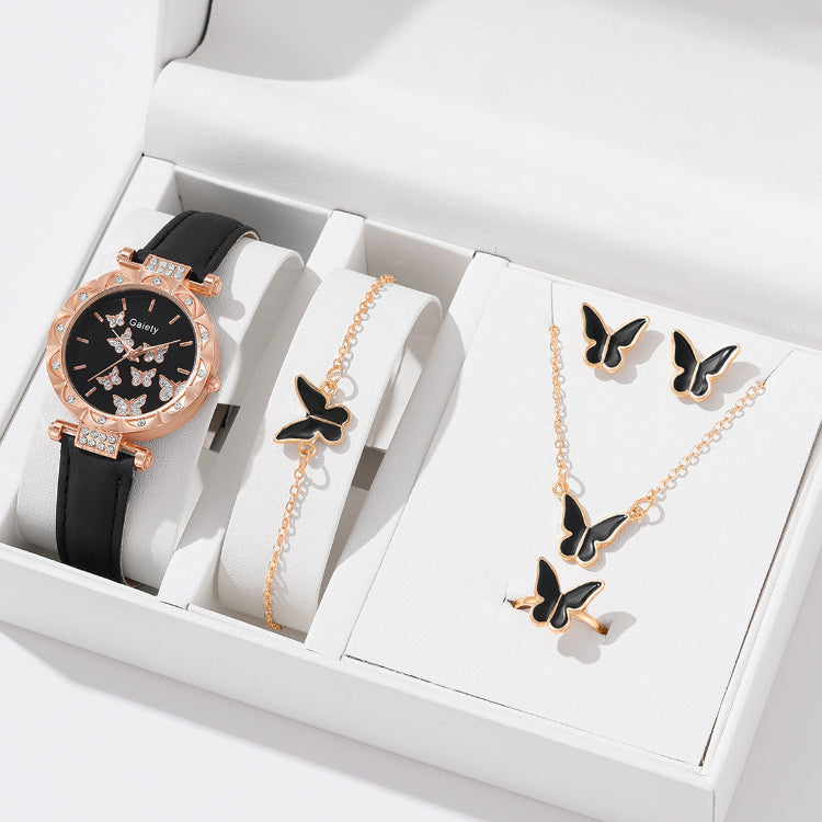 Jewelry set with a watch, bracelet, and necklace featuring butterfly designs in a white box.