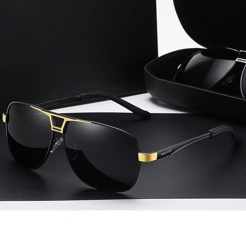 Black gold frame sunglasses with a gray tablet on a dark background