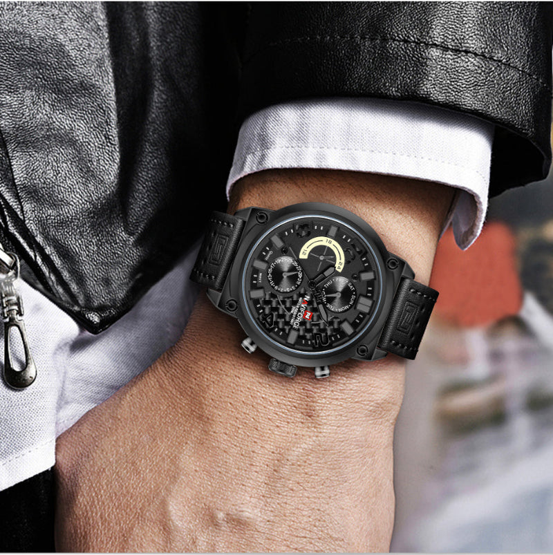 Black wristwatch on a person's wrist with a blurred background