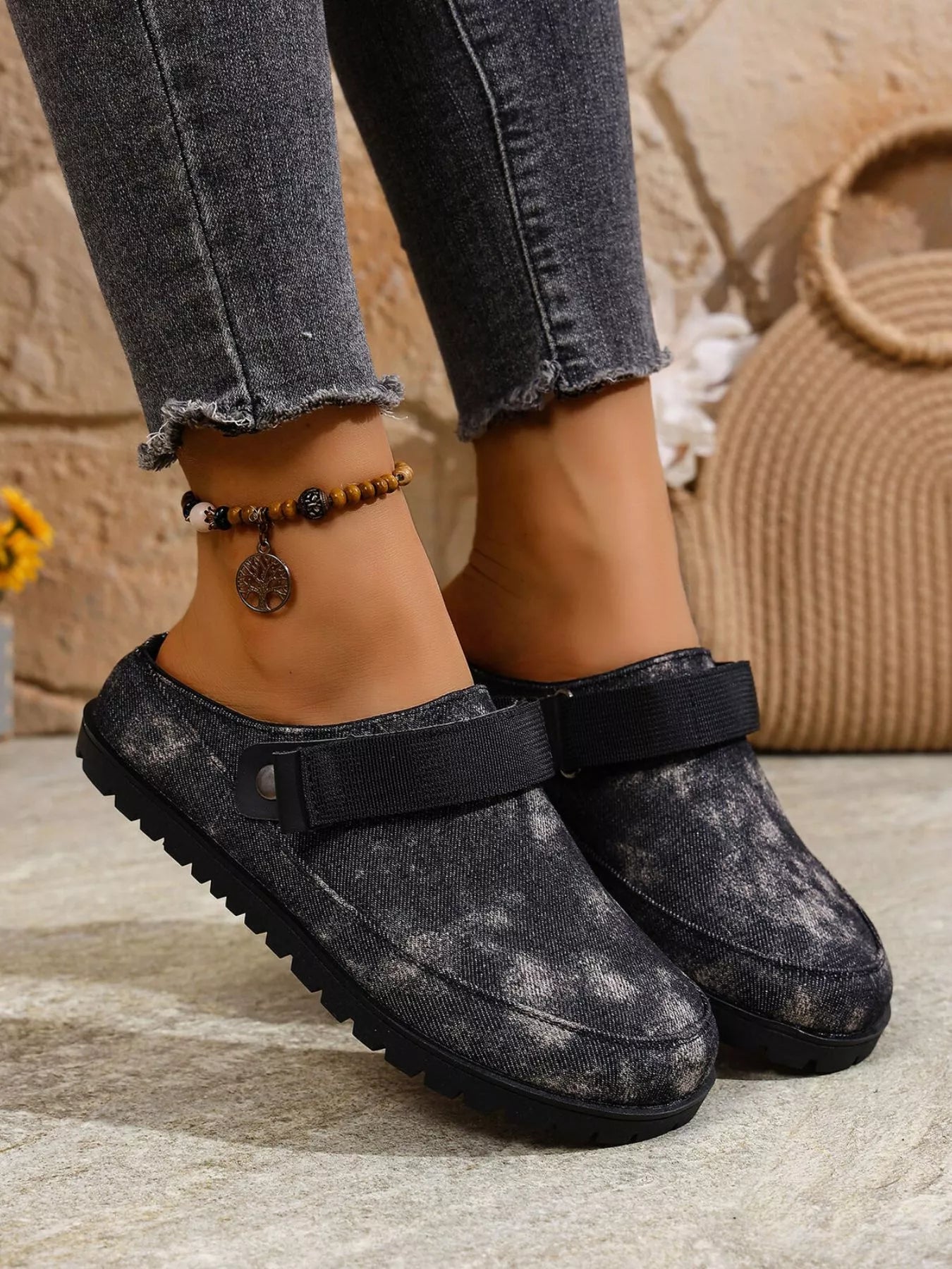 Dark gray round-toe slip-on flats with side strap and textured rubber sole