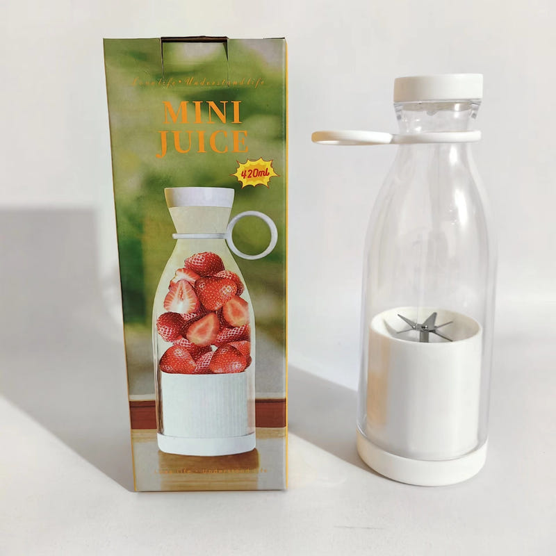 Mini juice blender bottle with white lid and clear cup showing stainless blades