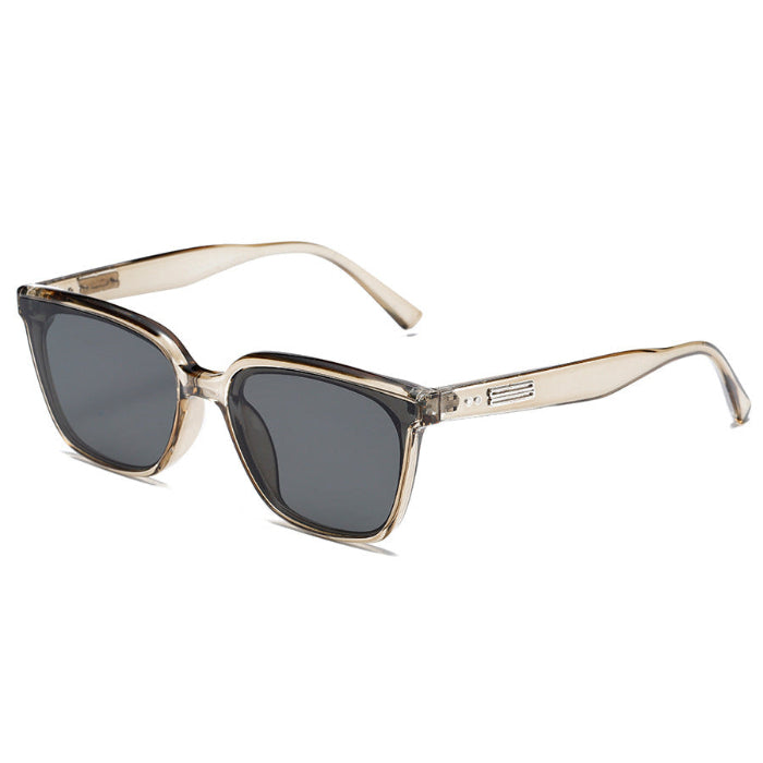 Sunglasses with gold frame and dark lenses on a white background
