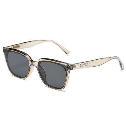 Sunglasses with gold frame and dark lenses on a white background