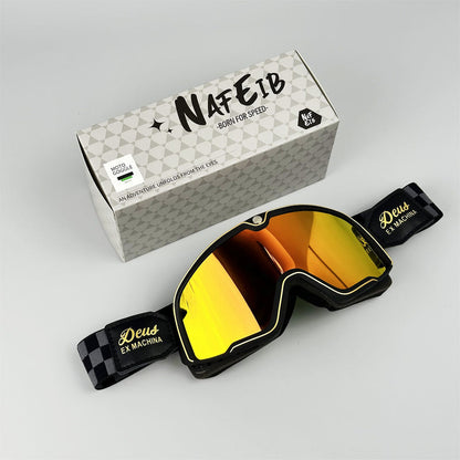 Black motorcycle goggles with yellow-orange reflective lens and adjustable strap