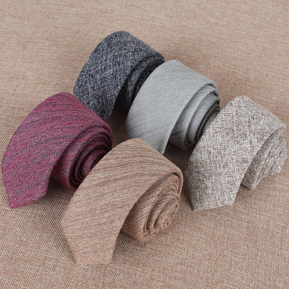Set of rolled-up socks in various colors on a textured surface