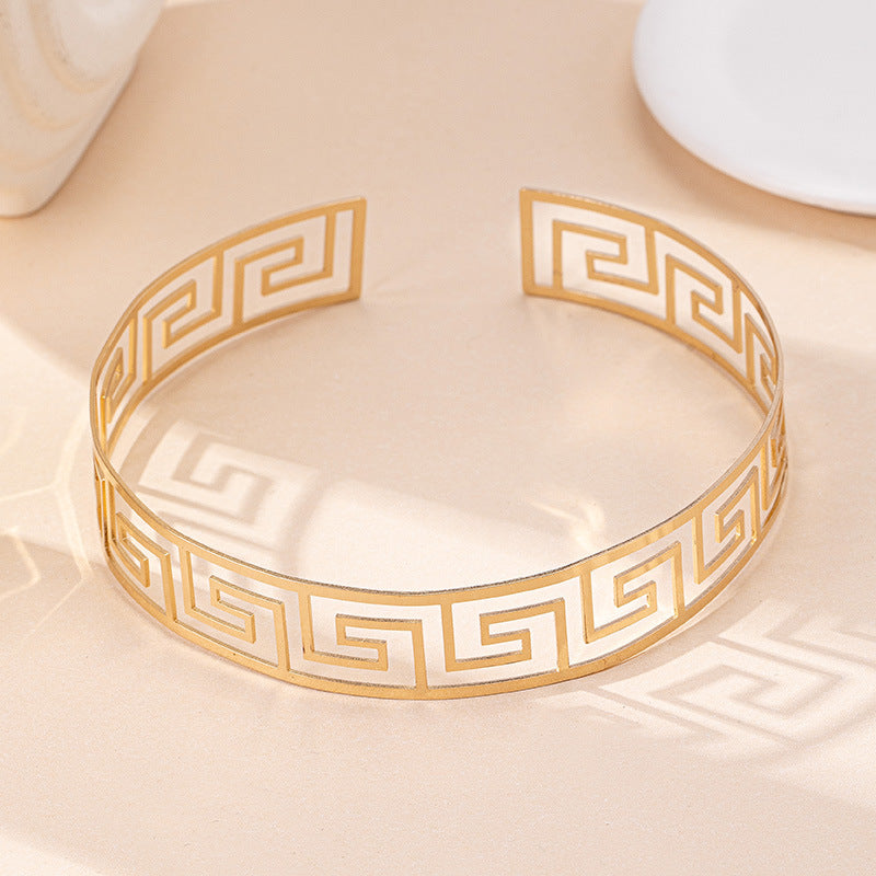 Gold and white bracelet on a matching dish
