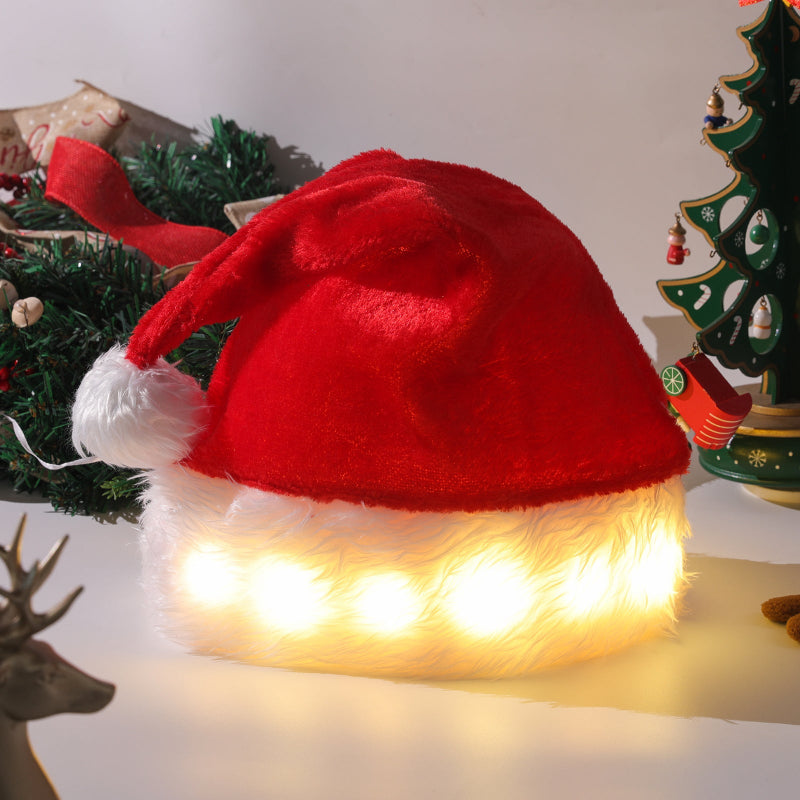 Red Santa hat with white fur trim and LED lights on a Christmas-themed background