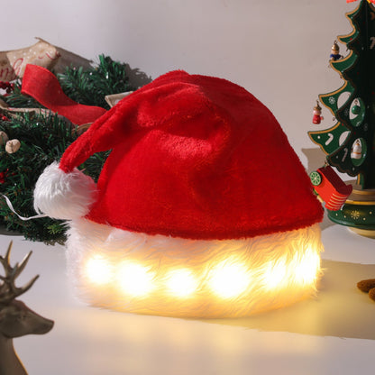 Red Santa hat with white fur trim and LED lights on a Christmas-themed background