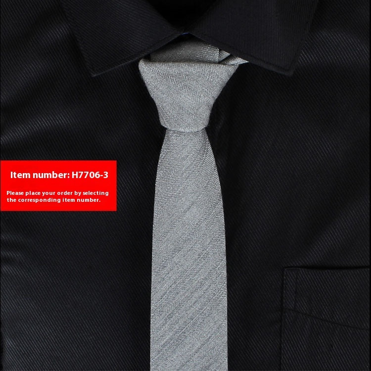Gray tie on a black shirt with a red item number label.