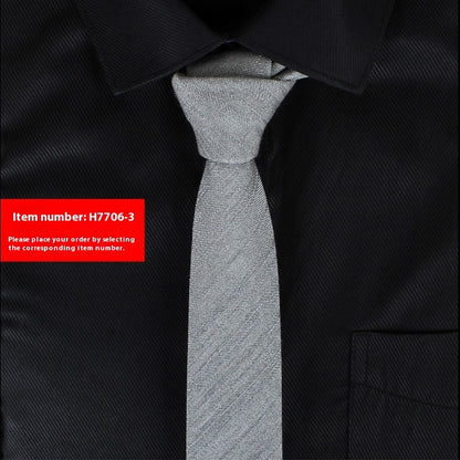 Gray tie on a black shirt with a red item number label.