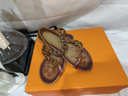 Women’s ethnic beaded sandals with rhinestone trim, shown in orange shoe box.