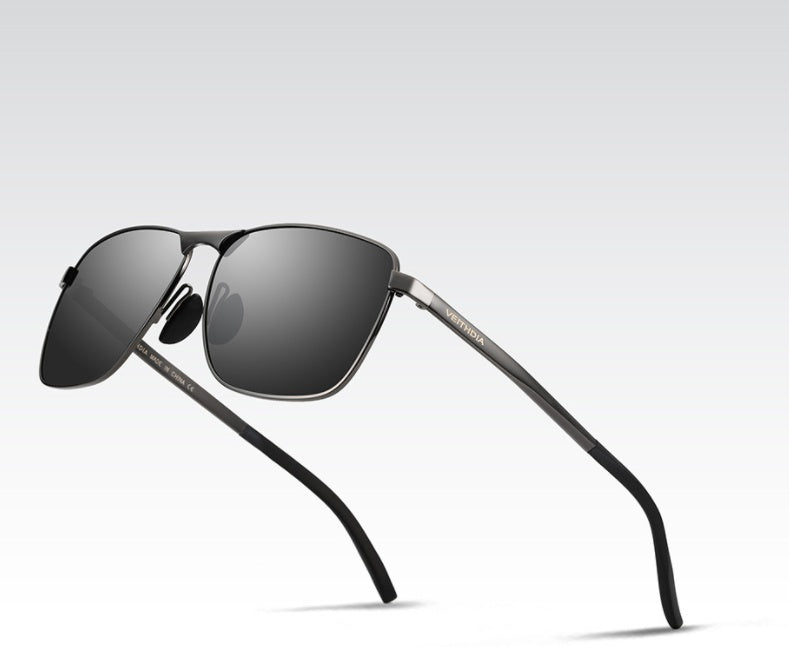 Sunglasses with black frames and dark lenses on a light gray background