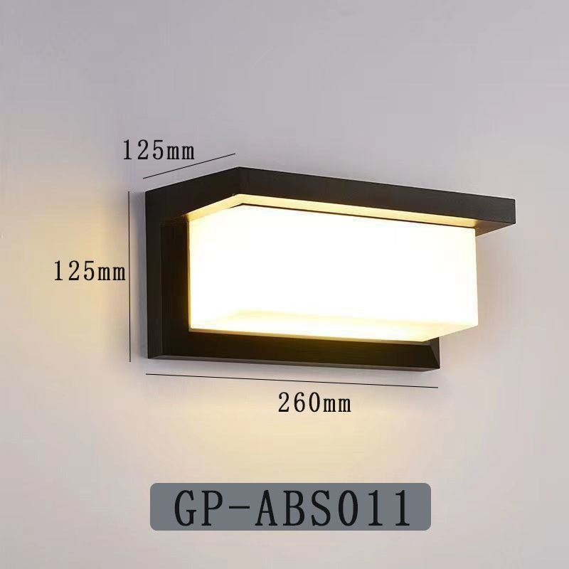 Black outdoor LED wall lamp with frosted diffuser emitting warm white light